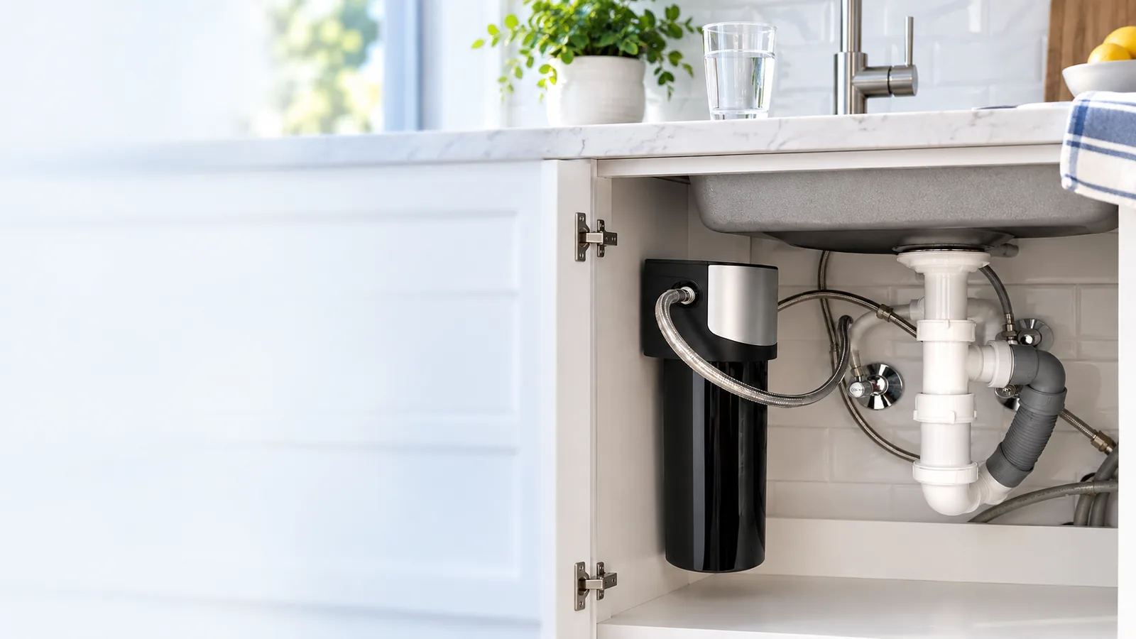 Installed under-sink water filter in a kitchen cabinet